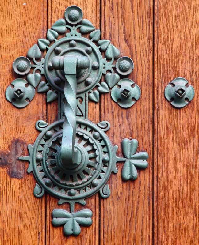 Traditional and decorated door knock over wooden door